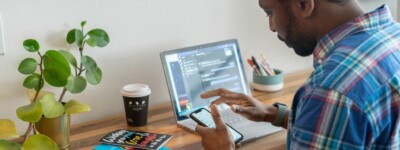Man on computer and phone