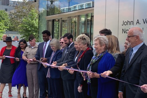 Photograph of President Sally Kornbluth, fifth from left, joins Governor Maura Healey and members of the federal government and Cambridge community for a ribbon cutting at the new John A. Volpe National Transportation Systems Center.