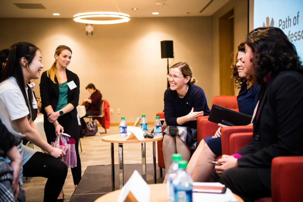 Speakers and attendees laugh together at the 2019 Path of Professorship conference.