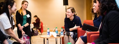 Speakers and attendees laugh together at the 2019 Path of Professorship conference.