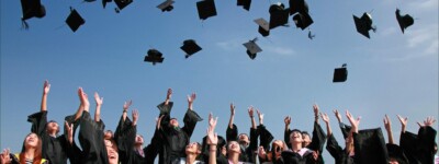 Students celebrating at a graduation ceremony.