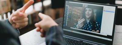 a person communicating with another via video chat, both of whom are using sign language
