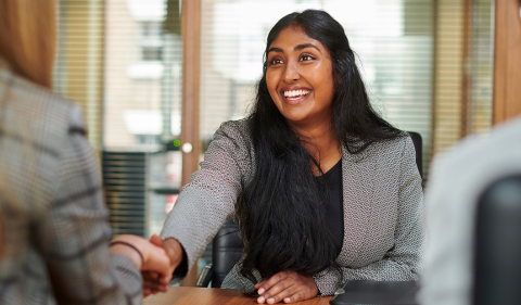 a woman interviewing and shaking the interviewers hand