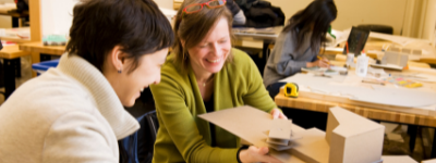 Instructor helping student with project