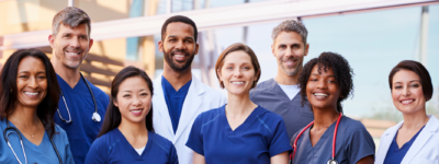 A group of smiling people in medical uniforms.