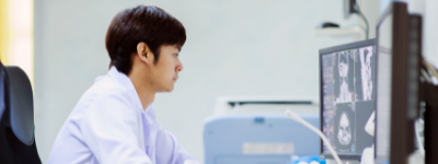 A person looks at lab computers.