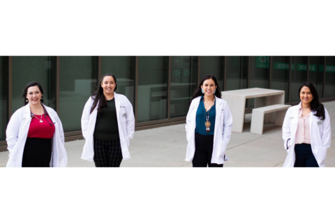 four women in lab coats