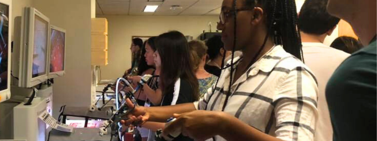 A group of students engaged in a live medical simulation.