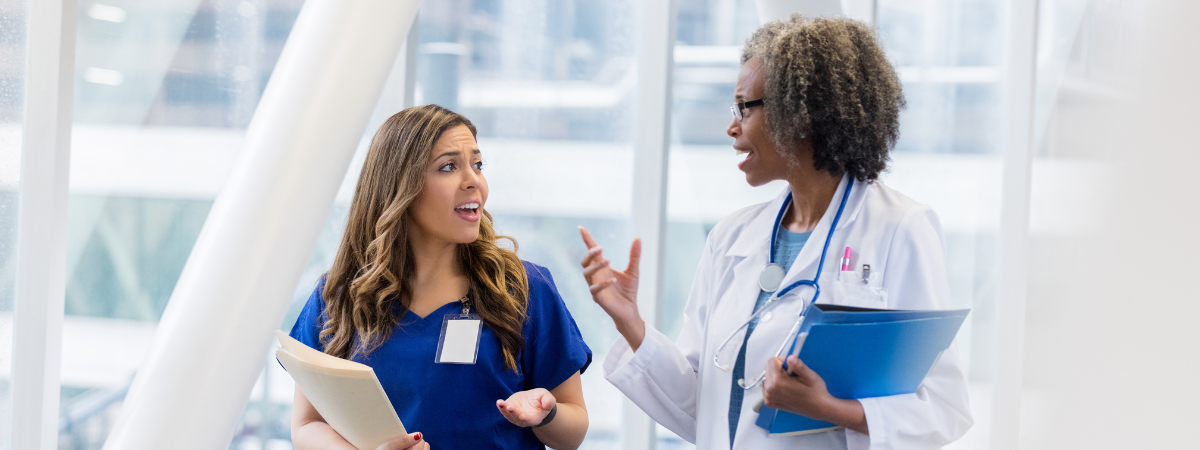 A physician talks to a nurse.