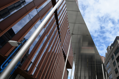 A close-up, looking towards the sky, of buildings in Kendall Square.