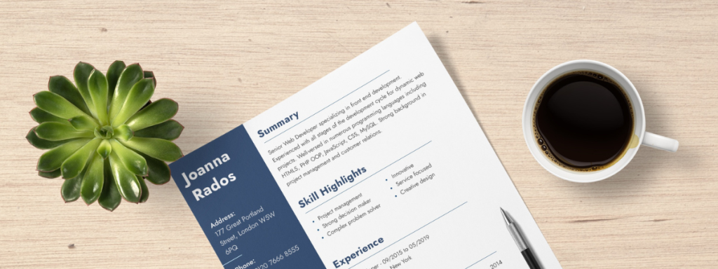 A corner of a resume sits on a table beside a succulent and a cup of coffee.