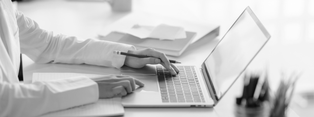 A person types on a laptop.